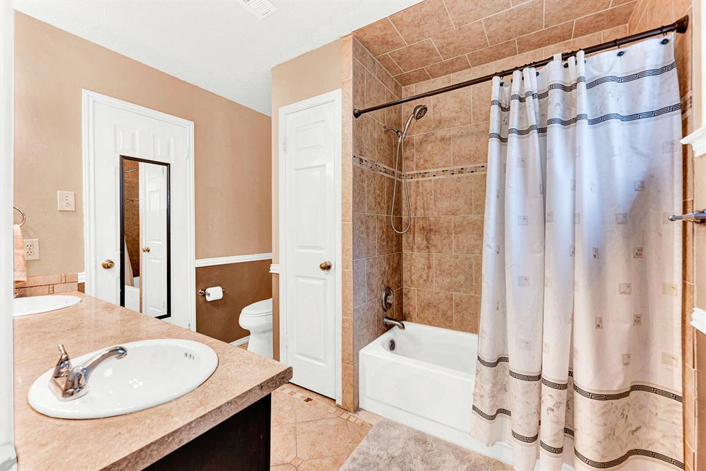 Rich earth-toned floor tiles lead to a fully tiled shower and tub surround, offering durability and warmth. End your day with a relaxing soak in the tub while enjoying your own private spa-like retreat.