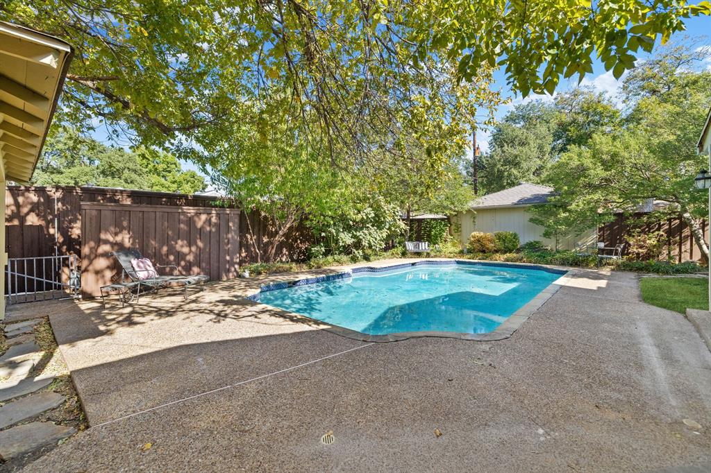 What a great backyard!  Tons of desk space for loungers, chairs, etc plus a big pool all in a picturesque yard.