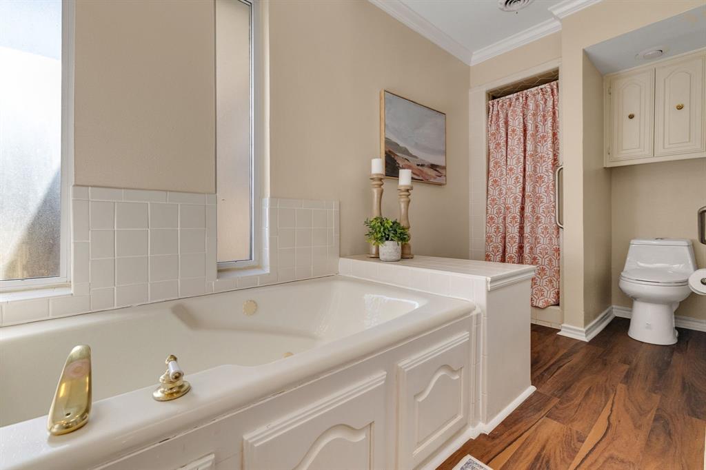 Another view of the primary ensuite bathroom showing the separate shower and toilet area.
