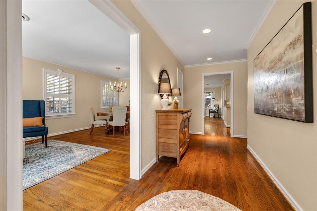 Come on inside and notice the gorgeous real nail down hardwood flooring, fresh paint throughout October 2026, crown molding, recessed lighting & extensive custom molding.