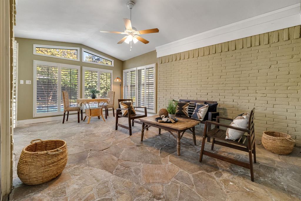 The sunroom is such a lovely room!  It has been permitted and added to the tax rolls, is air conditioned/heated with a central HVAC vent, has lighting, a ceiling fan, plugs, plantation shutters and a stone floor.