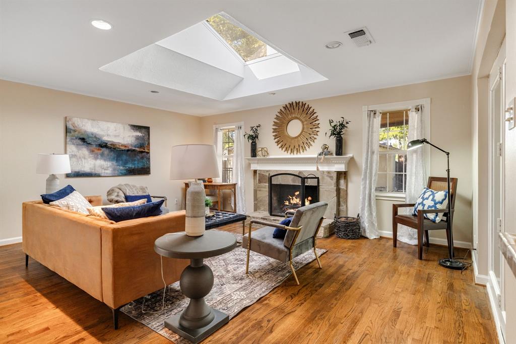 What a great space!  The wood floors continue through the family room that is complete with a large sky light and beautiful stone fireplace.