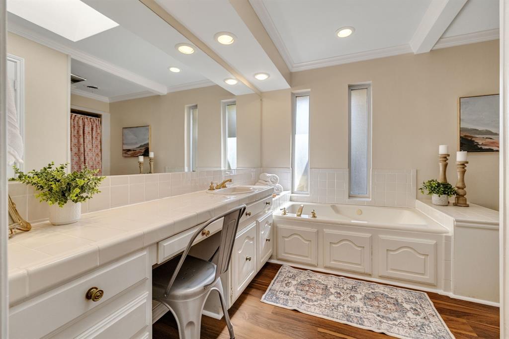 The ensuite primary bathroom is generously sized especially for a W. Richardson home.  It boasts new wood like vinyl flooring, a jetted tub and separate shower.