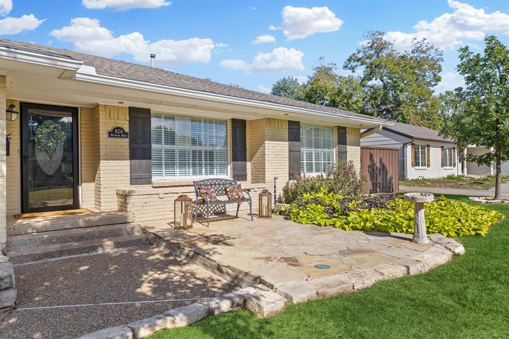 Lovely flagstone patio makes a great spot to relax and say hi to all the neighbors.  Painted brick, decorative shutters and upgraded windows add to the curb appeal.