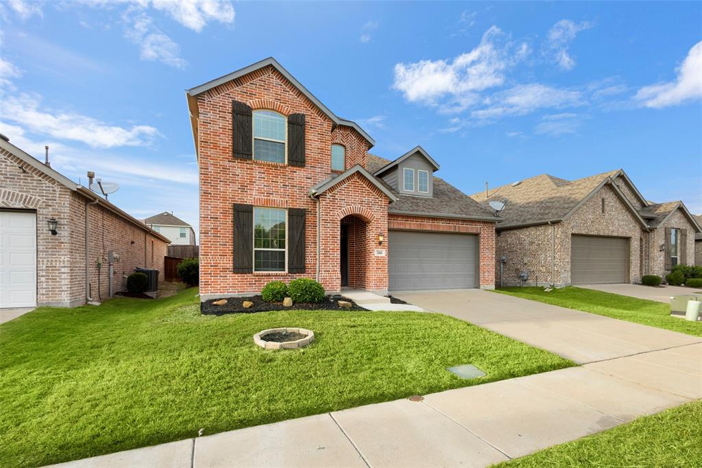 Two-story brick exterior featuring dark decorative shutters, a multi-gabled roofline, and an attached two-car garage