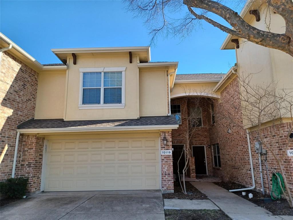 Brick and stucco exterior with a two-car garage