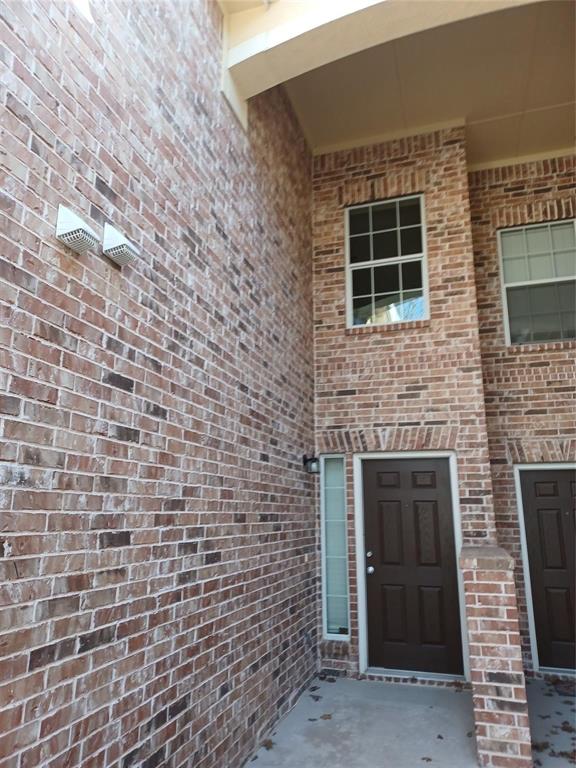 Multi-tone brick exterior facade with a covered entry