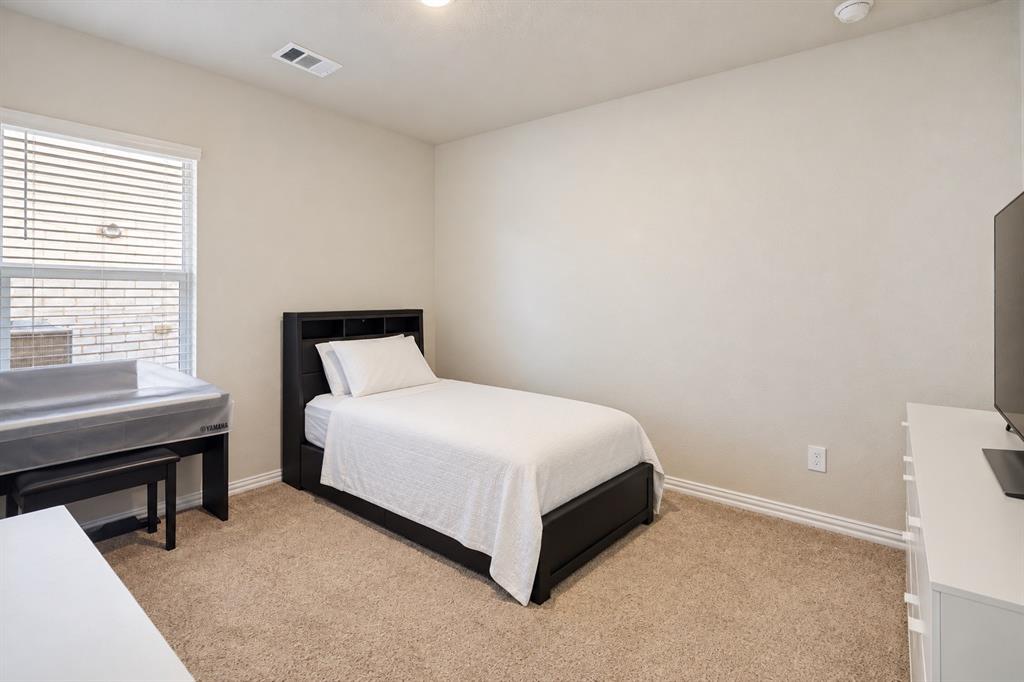 Neutral-toned interior featuring wall-to-wall carpeting, window with slatted blinds, and recessed lighting
