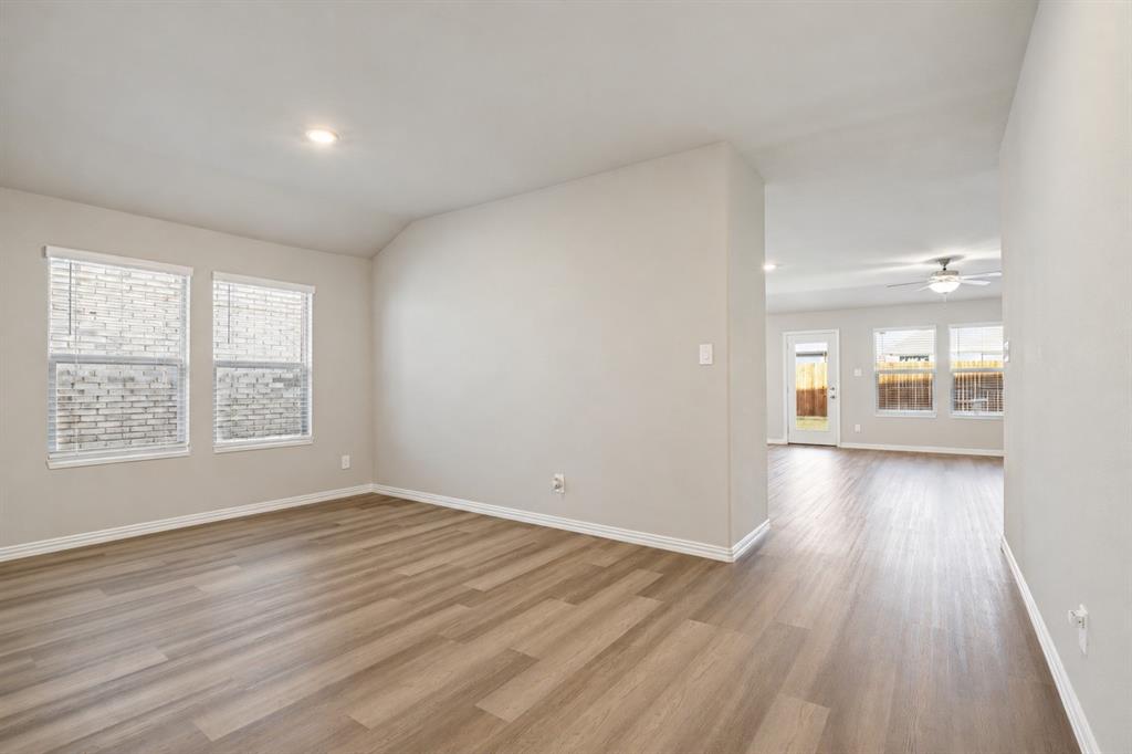 Neutral-toned interior featuring wood-finish flooring, recessed lighting, and a ceiling fan