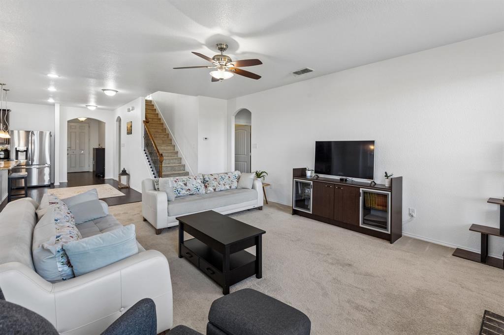Open concept living area with carpet flooring, recessed lighting, and a ceiling fan