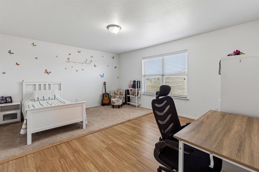 Wood-finish flooring, recessed lighting, and a window with blinds