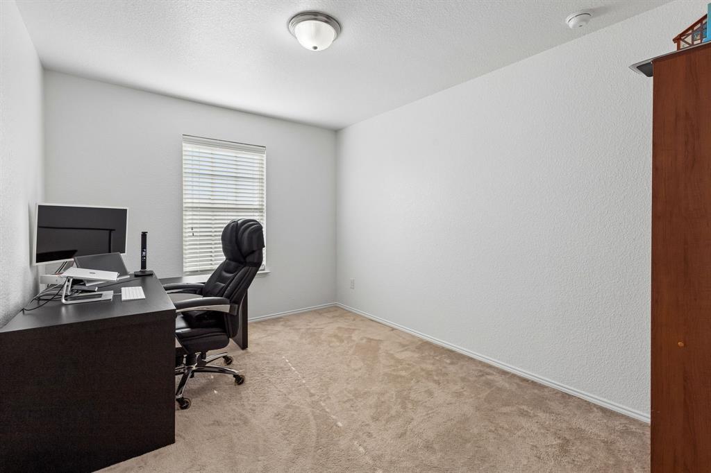 Neutral wall color, carpeted flooring, window with blinds, and ceiling-mounted light fixture