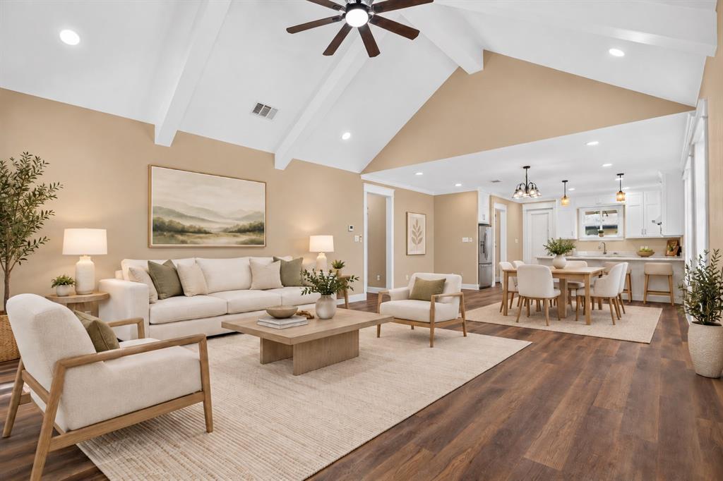 Virtual picture- Vaulted ceilings with exposed structural beams, wood-finish flooring, recessed lighting, and a kitchen featuring white cabinetry and a breakfast bar