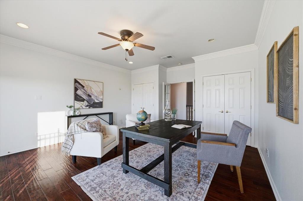 Wood-finish flooring, recessed lighting, crown molding, and dual-panel closet doors