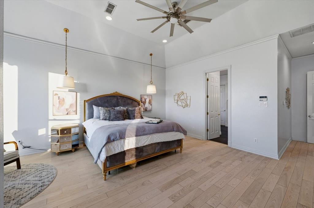 Vaulted ceilings, wood-finish flooring, recessed lighting, ceiling fan, and pendant light fixtures