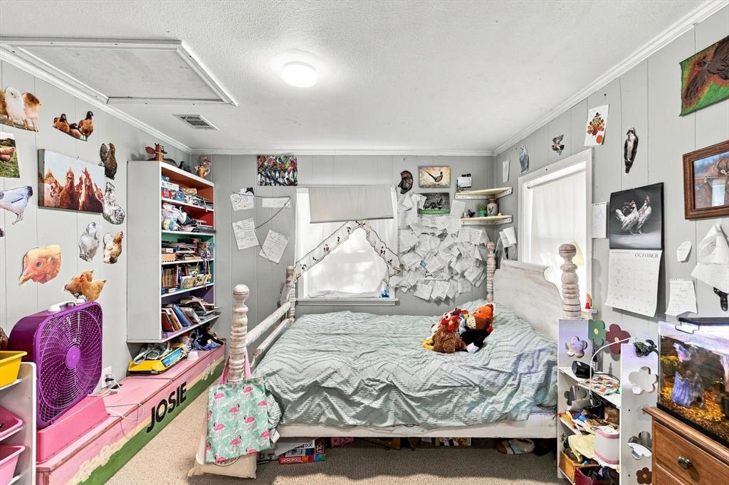 Room featuring neutral wall paneling, ceiling-mounted lighting, and carpeted flooring