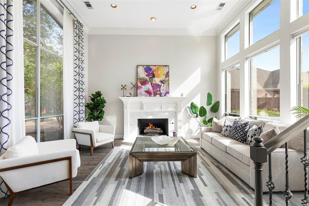 Spacious and bright the entry opens to the soaring front living room, with an iron-baluster staircase adding architectural detail.