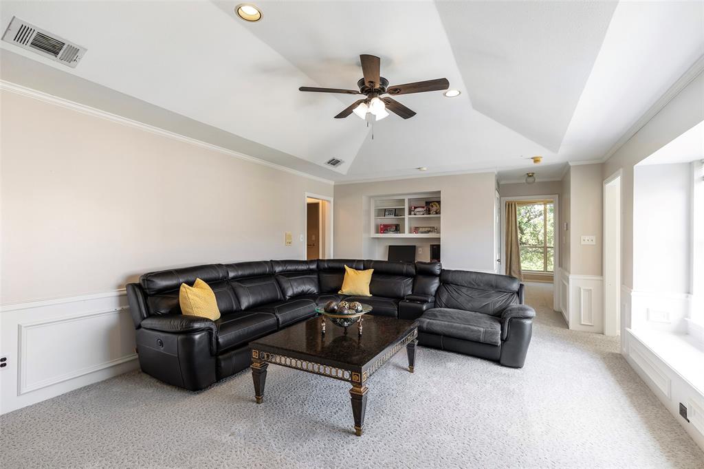 The upstairs gathering space is an inviting spot for football Sundays and movie nights, while a built-in desk and shelving provide a handy homework or computer nook.