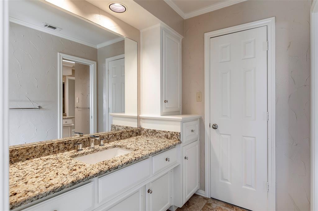 Jack and Jill vanity with built-in storage provides a dedicated place to get ready, with access to the shared tub, shower