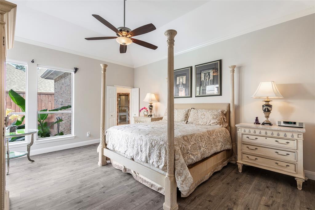 High ceilings, tall windows and room for king-size furnishings create a comfortable primary retreat with an adjoining bath.