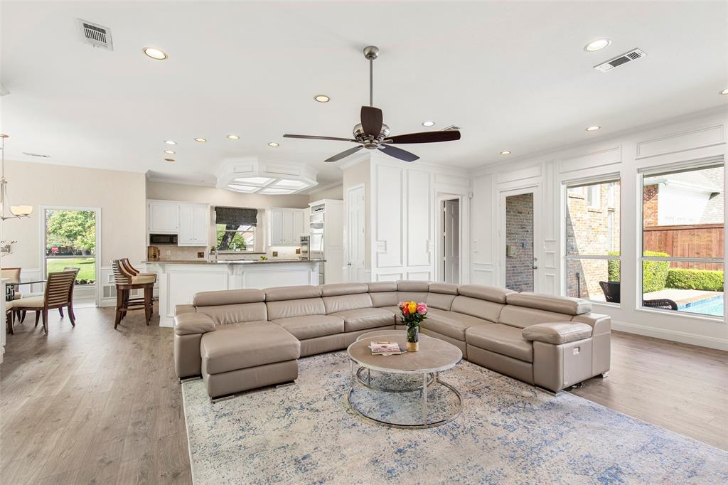 The open-concept layout seamlessly connects the spacious, light-filled family room to the adjacent dining area and kitchen, ensuring you never miss a moment of the conversation while entertaining.