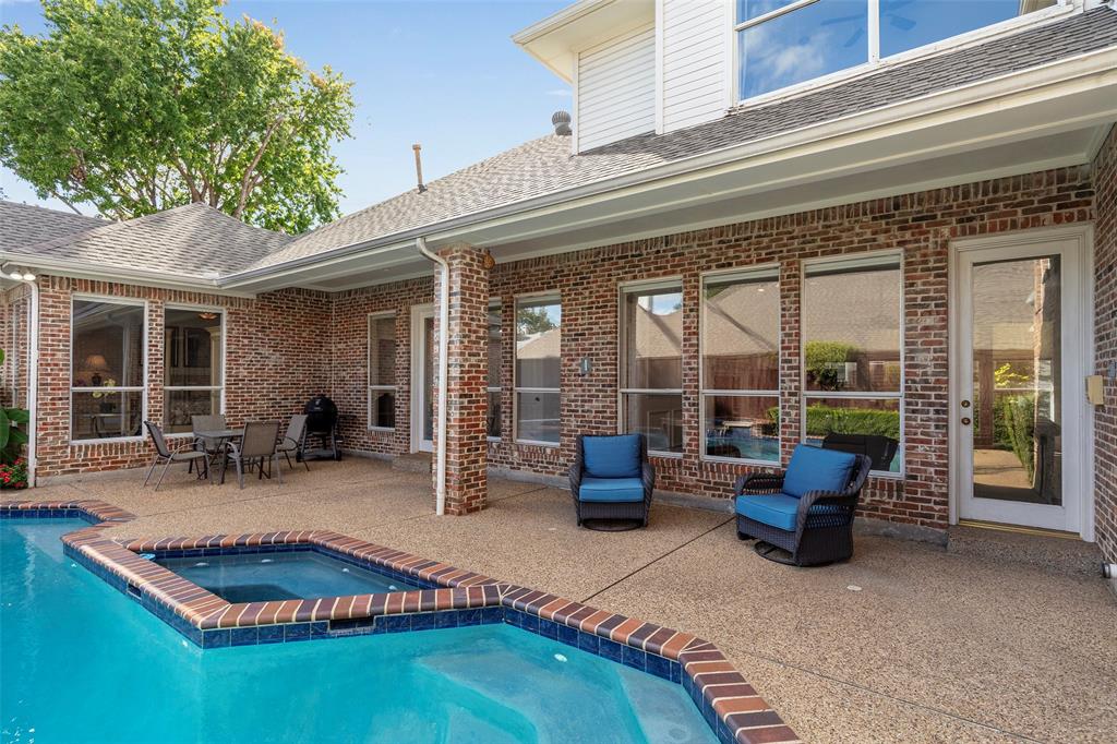 The expansive patio provides plenty of space for lounging or outdoor dining, positioned perfectly right alongside the elevated, built-in spa.