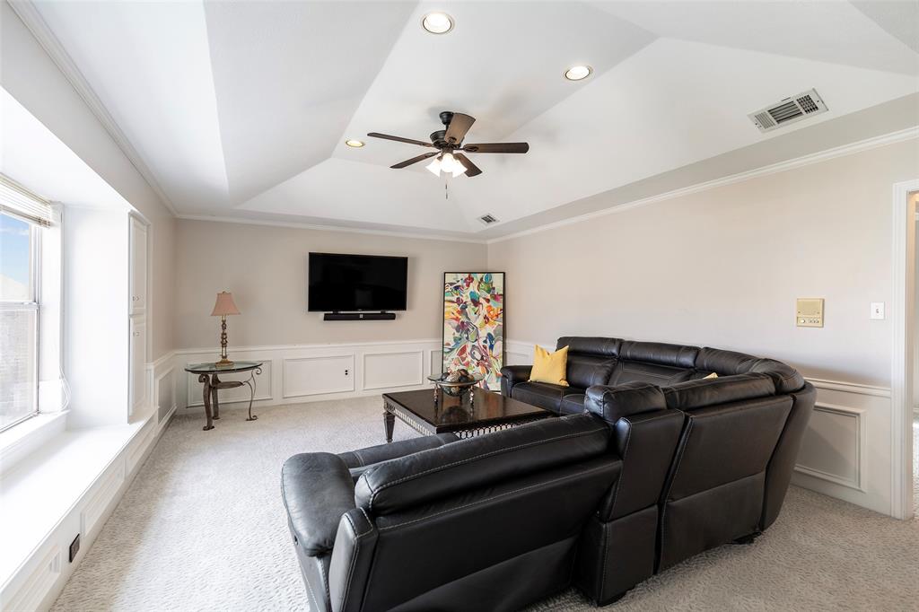 A wide window seat, built-in storage and a raised ceiling add character to this flexible second-floor living space.