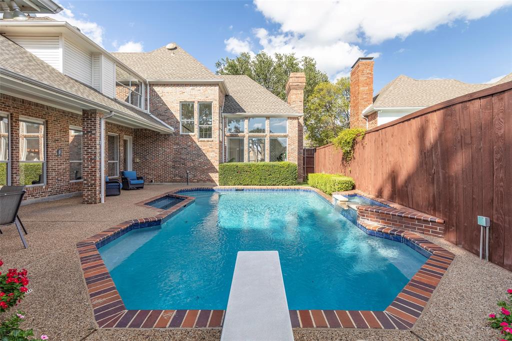 An entertainer's dream layout showcases the deep-water pool equipped with a diving board, surrounded by a robust, all-brick exterior structure.