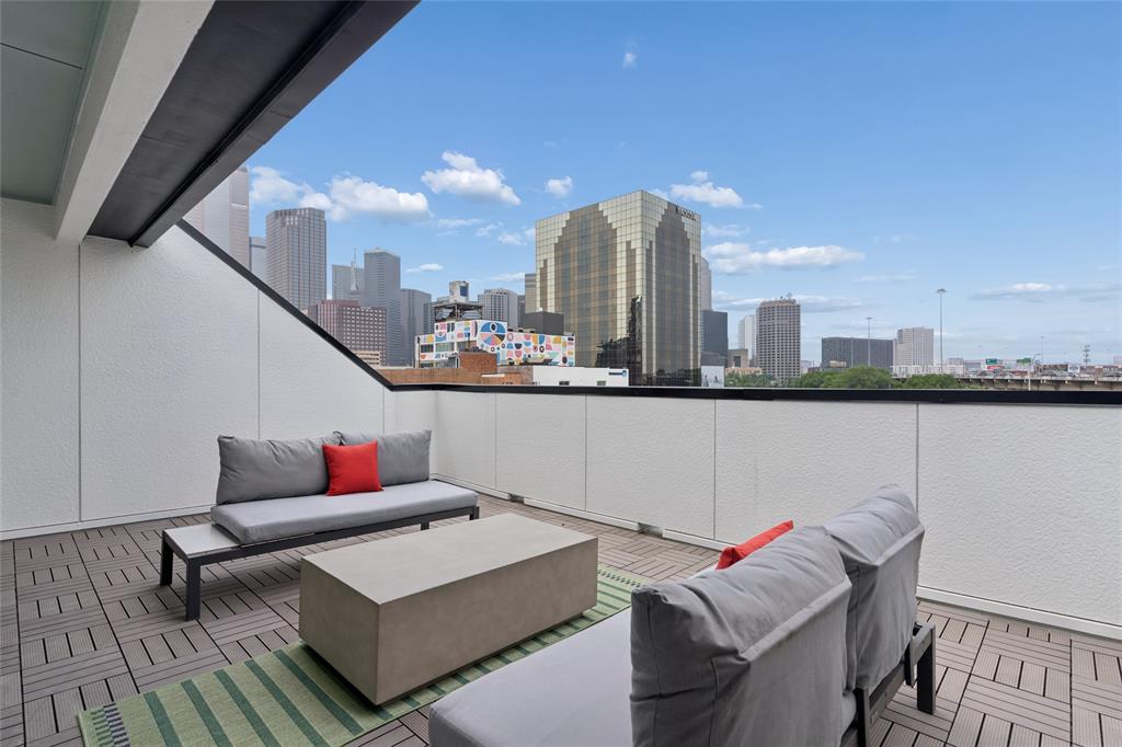 Private roof deck with views of the Dallas skyline. Image of model home with similar layout.