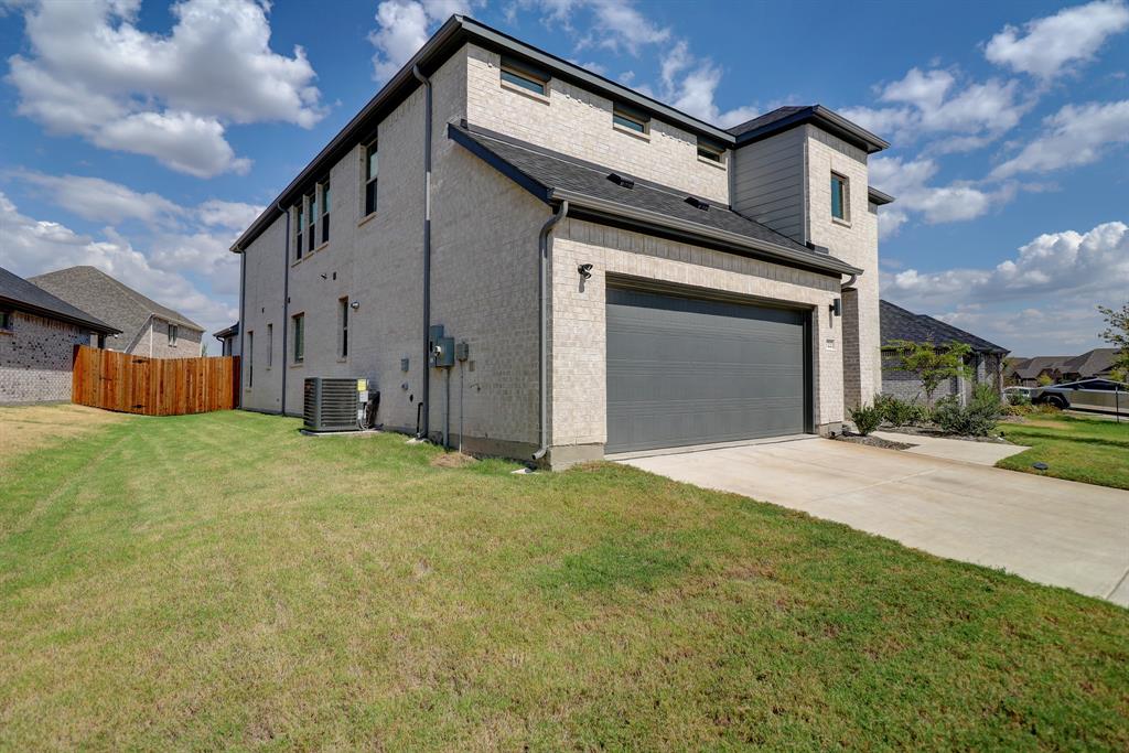 Two-story exterior with light-toned brick and stucco accents