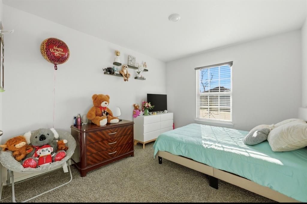 Neutral-toned wall-to-wall carpeting, single-hung window with horizontal blinds, and recessed ceiling lighting