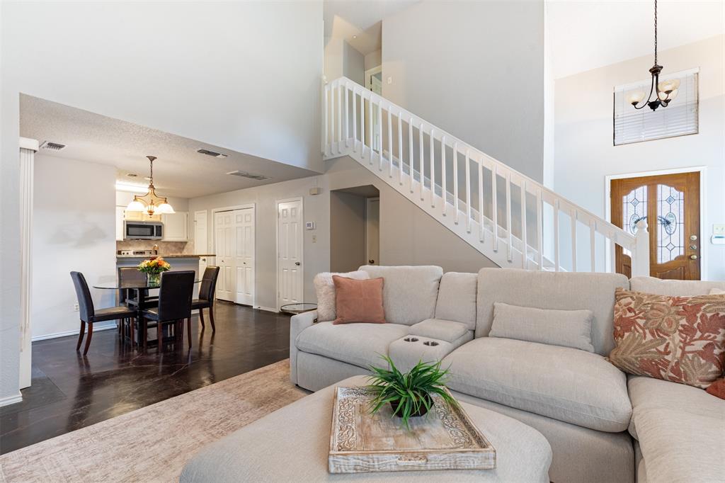 This expansive open floor plan creates a seamless flow between the living and dining areas, perfect for modern living and effortless entertaining. Large windows throughout the space offer abundant natural light and a bright, airy atmosphere.