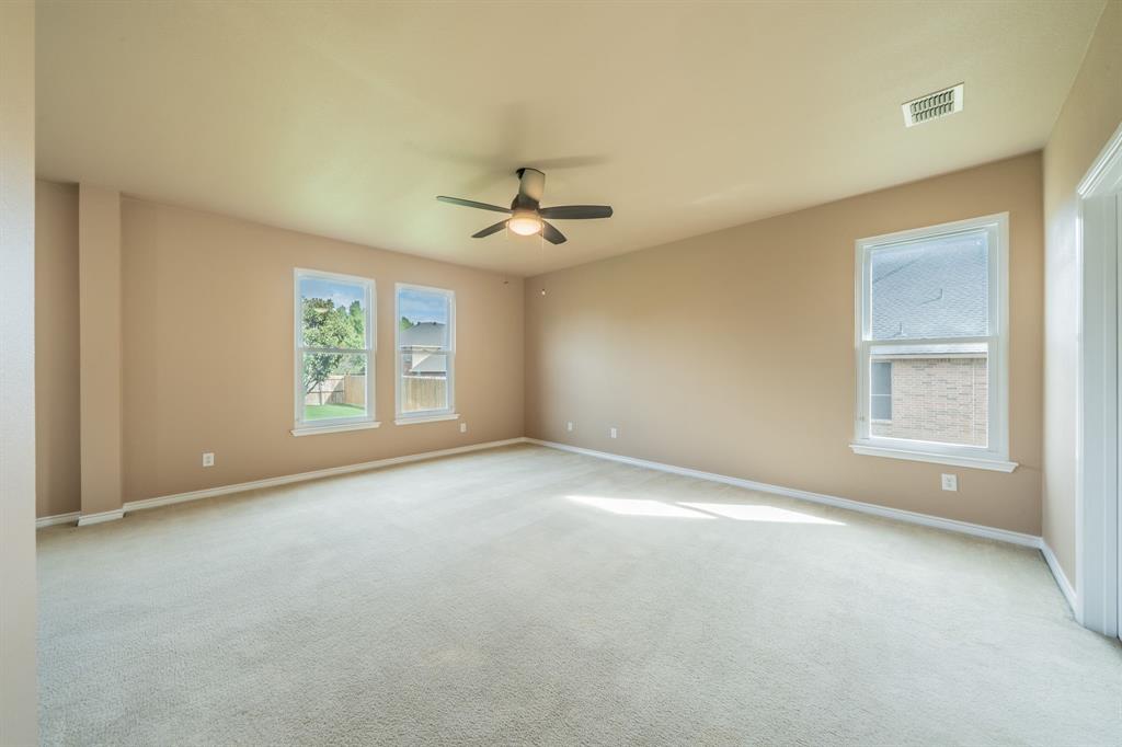 Master bedroom with ceiling fan.