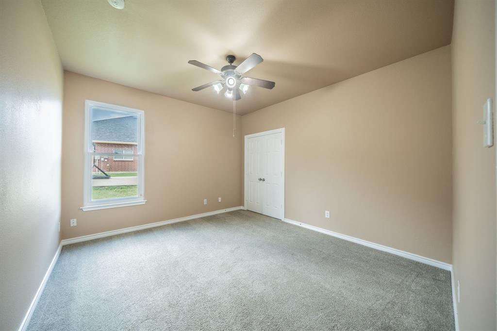 First floor fifth bedroom with ceiling fan.