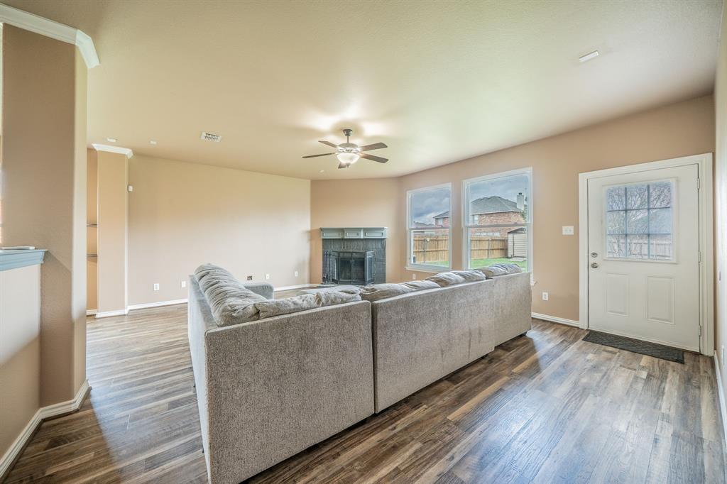 Family Room with fireplace, hearth and ceiling fan. Family Room with fireplace, hearth and ceiling fan.