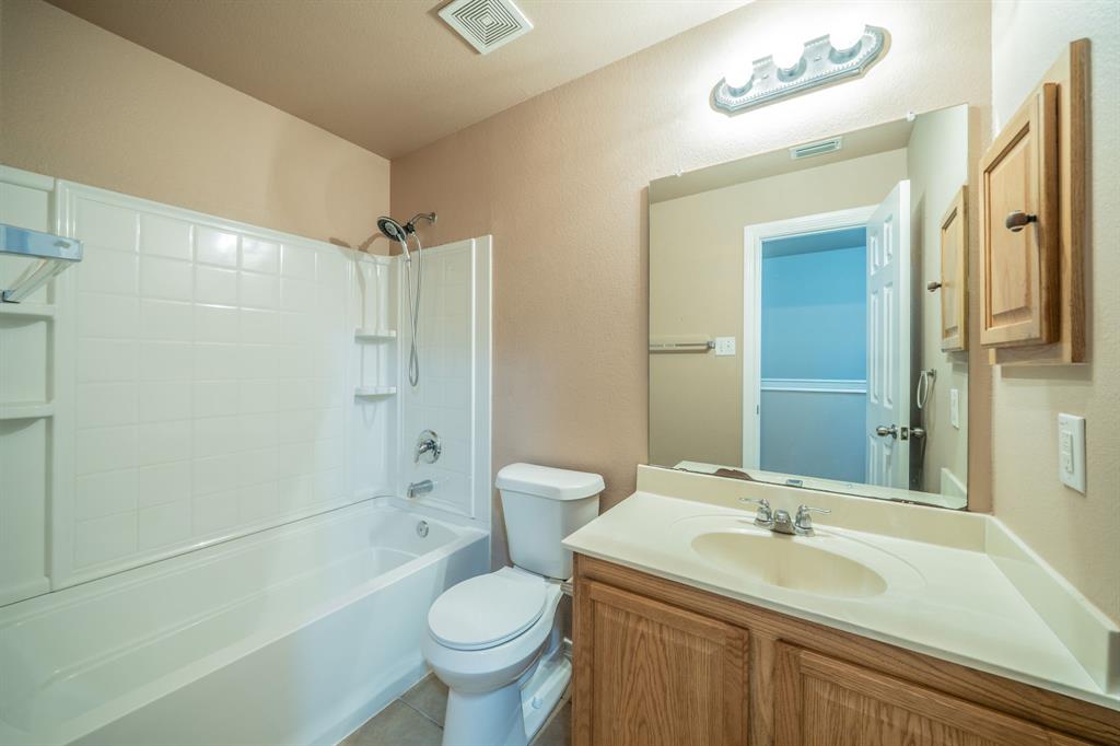 Second upstairs full bath with granite countertop, built-in cabinets and medicine cabinet.