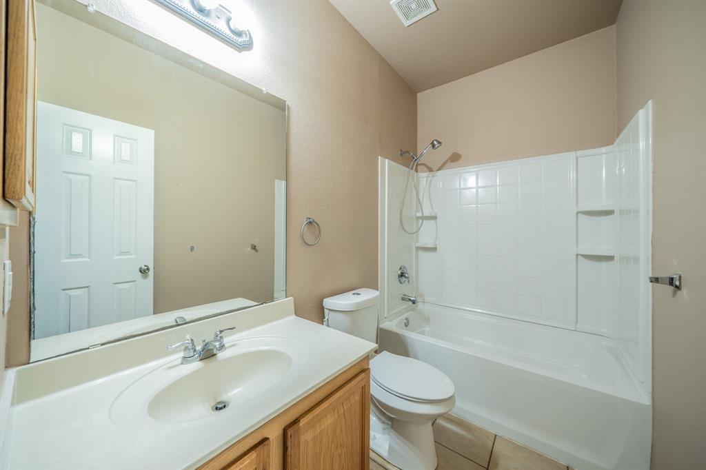 First floor full bath with built-in cabinets, granite countertop and medicine cabinet.