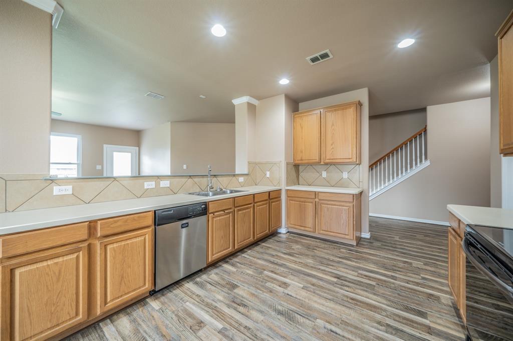 Kitchen with dishwasher and tile back splash. Kitchen with dishwasher and tile back splash.