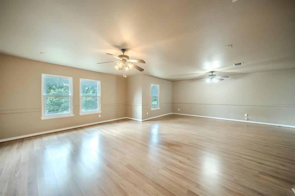 This large second floor living area has kind of a natural divide in the middle. This could be a game room and a media room or one large living area.