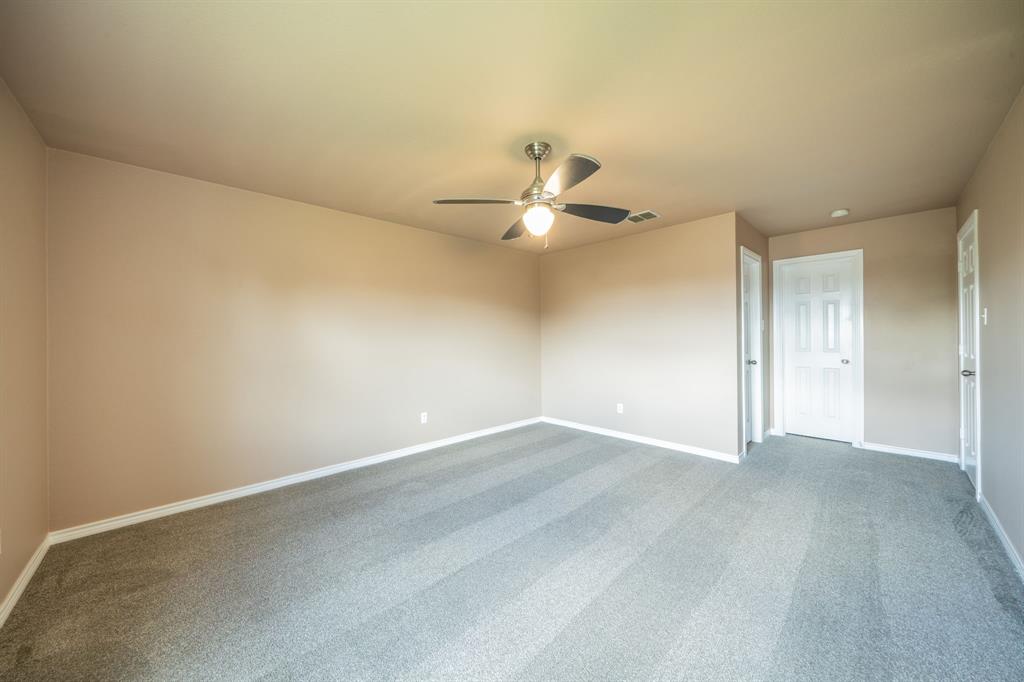 Upstairs bedroom with ceiling fan.
