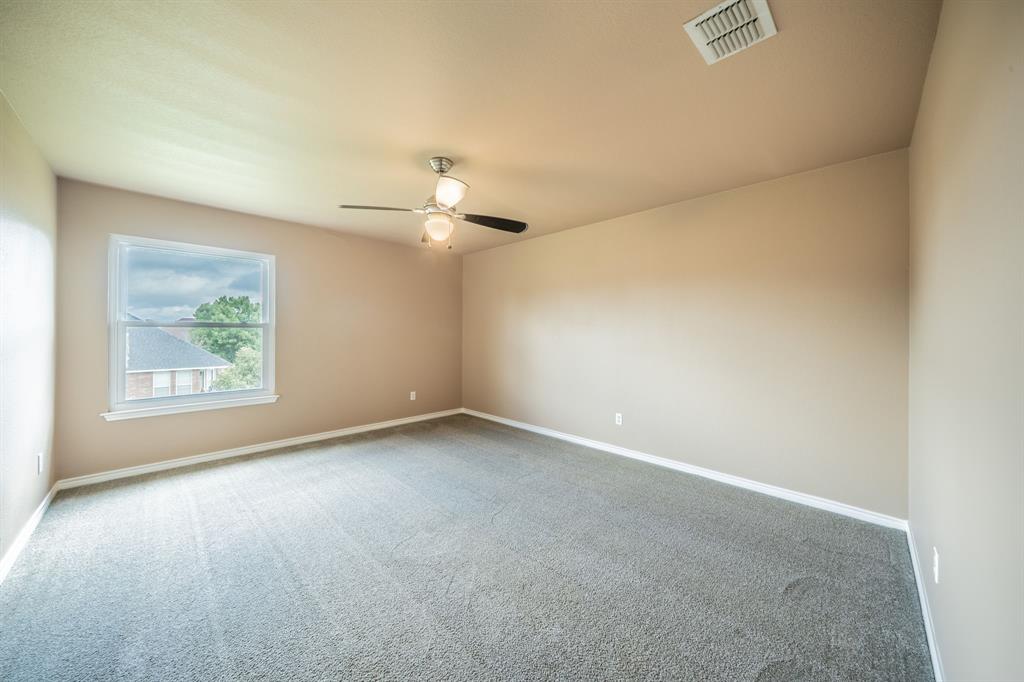 First upstairs bedroom with ceiling fan.