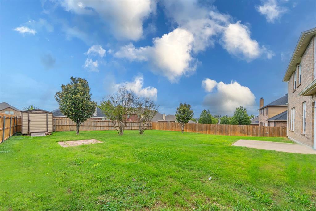 Backyard with view of 7.5' wide x 8' deep storage shed, 8' x 8' brick pavers for BBQ area or fire pit area, and concrete patio 12' wide and 10' deep.