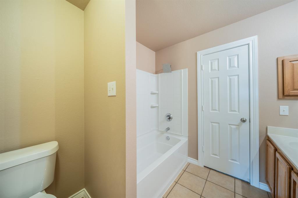 Upstairs jack and jill bathroom with built-in cabinets, medicine cabinet and granite countertop.