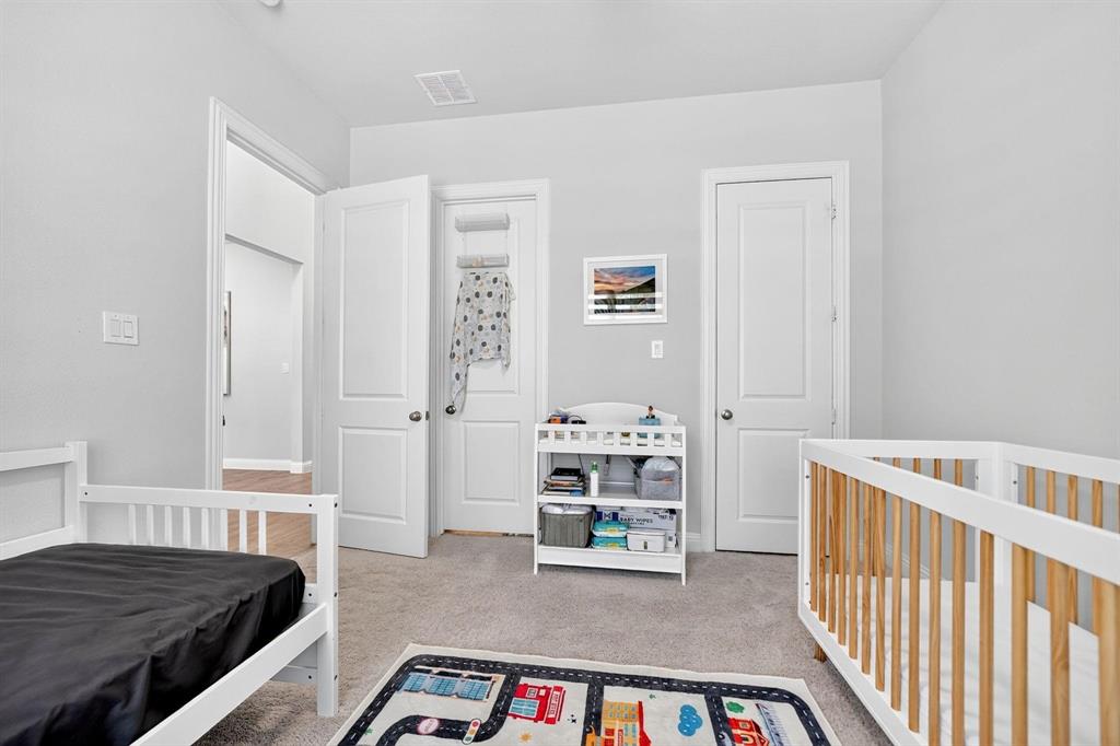 Neutral-toned room featuring neutral wall-to-wall carpeting, two interior panel doors, and one closet door