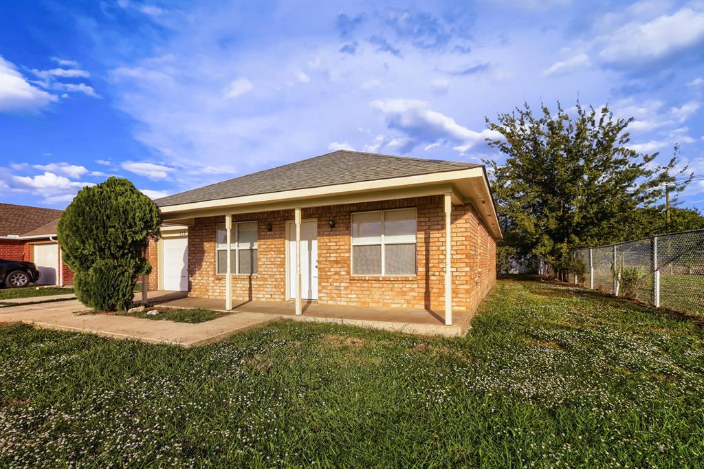 Single-story brick exterior featuring a covered front porch, asphalt shingle roof, and an attached garage Single-story brick exterior featuring a covered front porch, asphalt shingle roof, and an attached garage