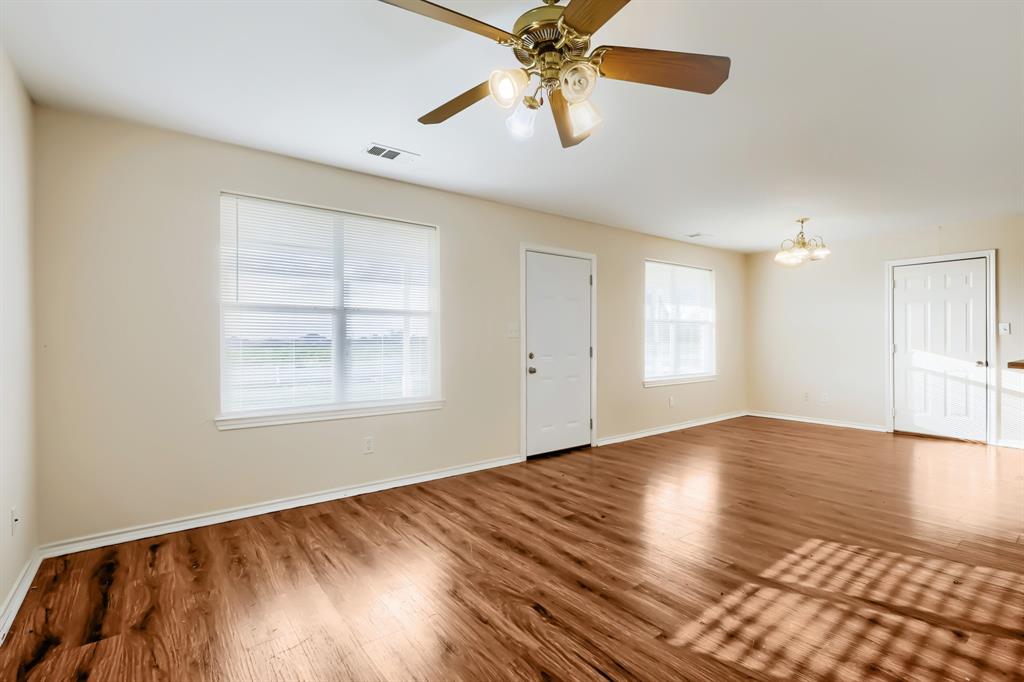 Large rooms featuring laminate wood flooring