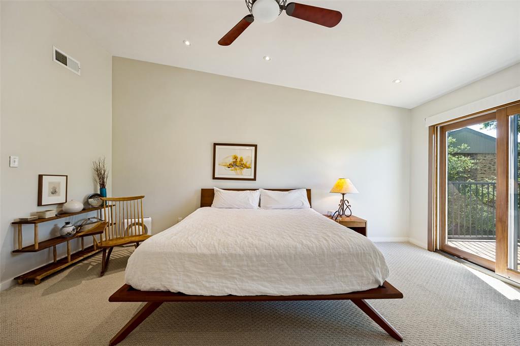 Vaulted ceilings featuring recessed lighting, a multi-blade ceiling fan, and sliding glass doors with wood-finished frames
