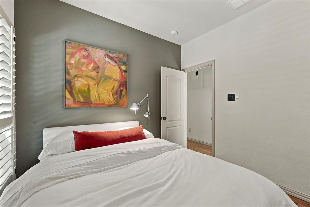 Accent wall in a neutral tone, wall-mounted adjustable metal light fixture, and classic two-panel interior door