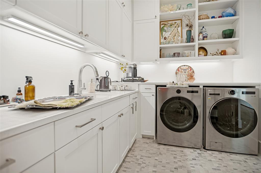 The laundry room with sink and cabinets to the ceiling. Lots of storage space