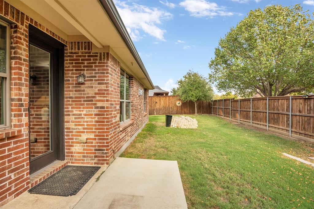 Big back yard has covered patio that faces east.
